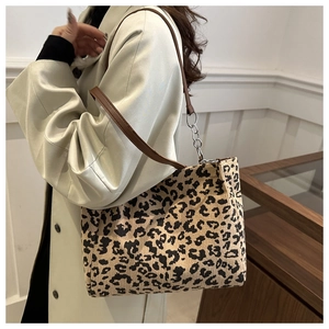 Detail of leopard print tote bag featuring corduroy texture and premium leather strap