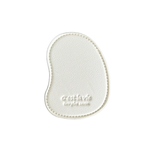 White leather mango-shaped phone grip with c'est la vie embossing and hand-stitched edges