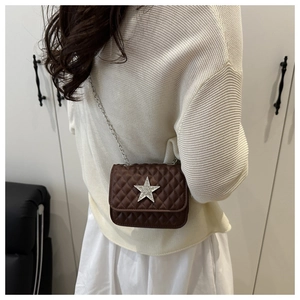 Brown quilted crossbody bag with silver star detail shown on a model from the back side