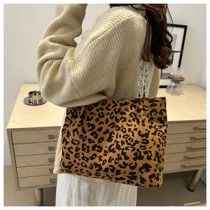 Detail of leopard print tote bag featuring corduroy texture and metal chain strap