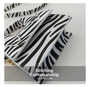 Macro shot of stitching craft on zebra pattern handbag with white contrast seams