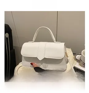 Detailed close-up of white PU leather crossbody bag with detachable strap and metal buckle