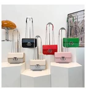 Close-up of stylish mini chain square bags with round metal buckles in various colors