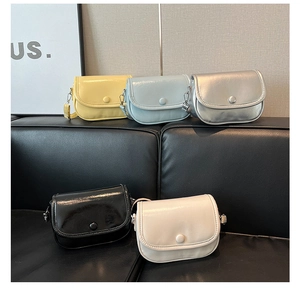 Five assorted minimalist saddle bags in yellow, blue, silver, black, and cream white
