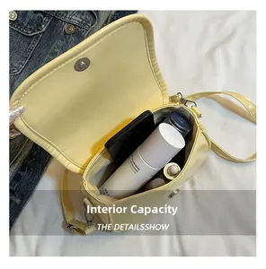 Internal capacity of yellow crossbody bag showing space for phone and makeup