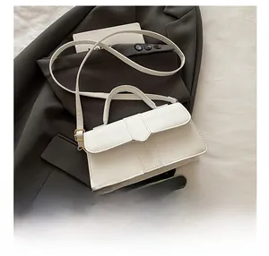Detail showing the white baguette bag capacity with a smartphone as reference