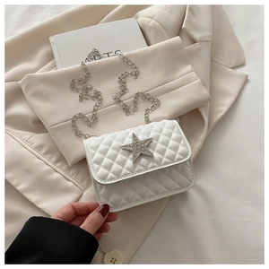 Detail shot of white quilted crossbody bag with sparkling rhinestone star and chain strap