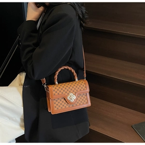 Retro brown leather square bag featuring geometric patterns and a silver flower lock