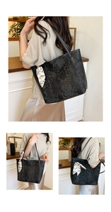 Detailed view of black snakeskin tote bag with geometric scarf on double handles