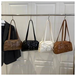 Detail of multi-color bow shoulder bags with lace-up straps and metallic ring buckles