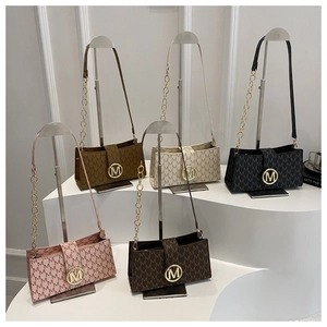 Detailed display of vintage monogram flap bags in pink, brown, white and black colors