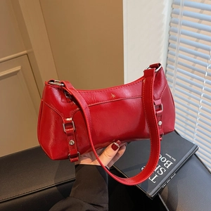 Minimalist bright red patent leather baguette shoulder bag with metallic buckle and strap