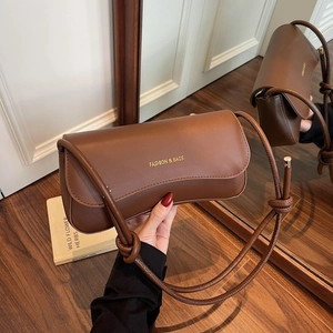 Minimalist brown PU leather shoulder bag with gold lettering and knotted strap detail