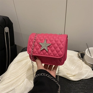Magenta quilted chain crossbody bag featuring a large rhinestone star on the front