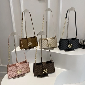 French vintage underarm bags with M-letter monogram print and golden metal buckle