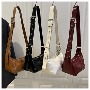 Detail view of stylish pillow bags in four colors with eyelet straps and shiny finish