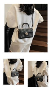 Close-up of black and grey checkerboard mini bag with golden floral twist lock