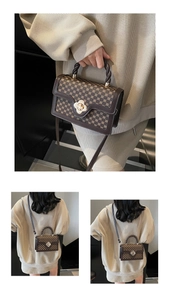 Detail of vintage square bag with floral gold clasp and geometric monogram pattern