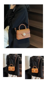 Macro view of retro brown printed square bag with silver flower lock and woven handle