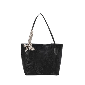Black snake-embossed large tote bag for women featuring a silk scarf and metal logo