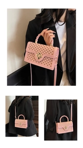 Close-up of pink monogram crossbody bag with gold flower twist lock and braided handle