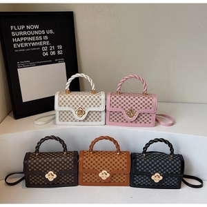 Five assorted vintage checkered crossbody bags with metallic floral clasps on display