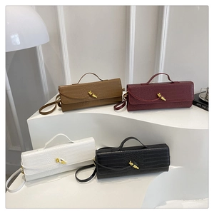 Detail of crocodile pattern baguette bags in four colors with gold artistic twist locks