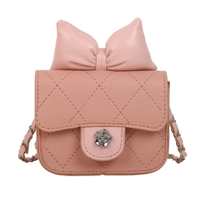 Pink quilted shoulder bag with bow and camellia clasp on white background