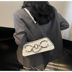 Close-up of white crocodile texture faux leather bag with stylish silver metal hardware