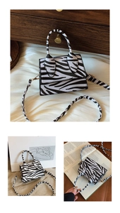 Detail of zebra print mini crossbody bag featuring textured faux leather and top handle