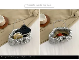 Internal view of silver pleated clutch showing capacity for phone and cosmetics