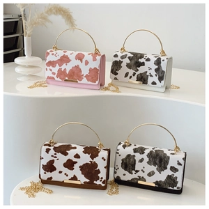 Stylish cow print crossbody handbags in four colors featuring gold metal handles