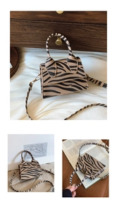 Detailed view of the zebra print texture and golden hardware on this mini crossbody bag