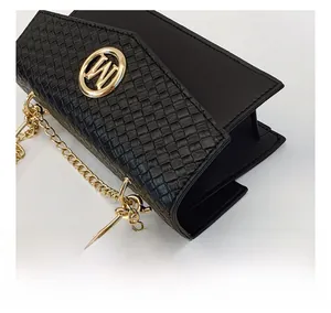 Close-up of black woven texture handbag with golden W buckle and elegant chain strap