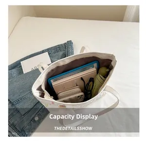 Detailed interior of large white canvas tote bag showing high storage capacity