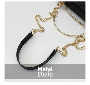 Close-up of woven bag featuring premium gold chain strap and large metallic ring hardware