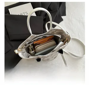 Internal view of the white floral tote bag showing space for a wallet and smartphone