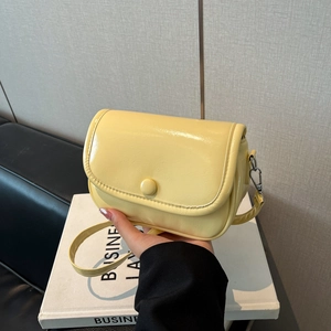 Minimalist bright yellow glossy crossbody bag with adjustable strap for summer style