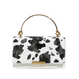 Stylish cow print crossbody bag for women with gold metal handle and chic design