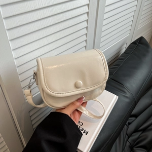 Minimalist cream shoulder bag with smooth PU leather and elegant round buckle closure
