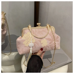 Pink floral handbag with vintage metal frame closure and beaded tassel charm detail