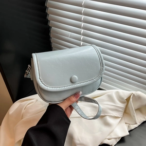 Minimalist mint blue flap crossbody bag in textured faux leather with silver buckle