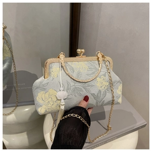 Detail of vintage gray floral kiss-lock bag with gold frame and white beaded tassel