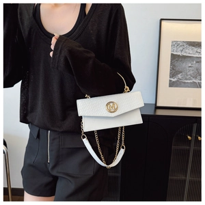 Detail of white woven flap bag with snake embossing and gold metal M hardware