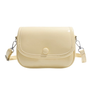 Minimalist light yellow lychee pattern crossbody bag with rounded saddle shape and strap