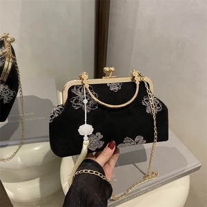 Elegant black embroidered satin handbag with floral patterns and gold metal handle