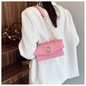 Pink crossbody bag featuring crocodile texture detail and golden metal M logo buckle