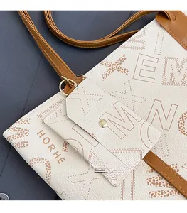 Detail of cream tote bag with HORHE lettering and leopard print pattern on leather
