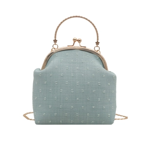 Minimalist light blue crossbody bag with vintage metal handle and floral texture
