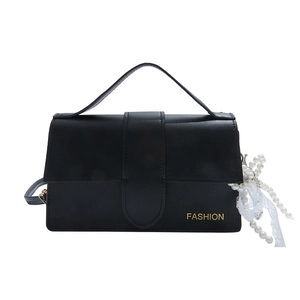 Minimalist black rectangular shoulder bag with top handle and elegant pearl charm detail